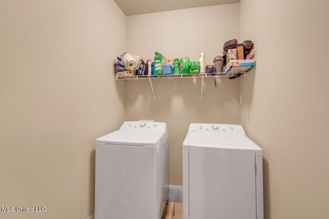washroom with independent washer and dryer and laundry area