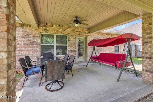 view of patio / terrace featuring ceiling fan, fence, and outdoor dining space
