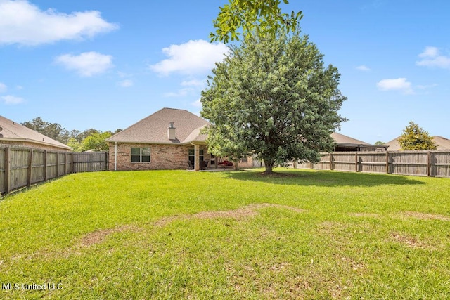 view of yard with a fenced backyard