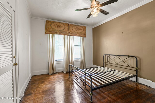 2418 24th Ave, Meridian, MS 39301 - bedroom with wood finished floors, ornamental molding, baseboards, and a textured ceiling