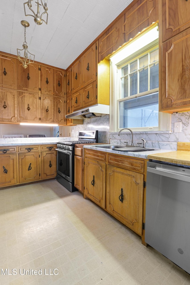 2418 24th Ave, Meridian, MS 39301 - kitchen featuring stainless steel appliances, a sink, under cabinet range hood, a chandelier, and light flooring