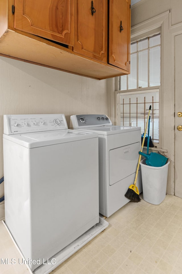 2418 24th Ave, Meridian, MS 39301 - laundry room with cabinet space, independent washer and dryer, and light flooring