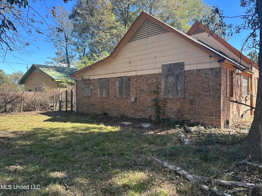 view of property exterior with a lawn