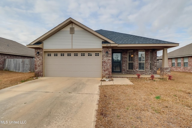 view of front of property featuring a garage and a front yard