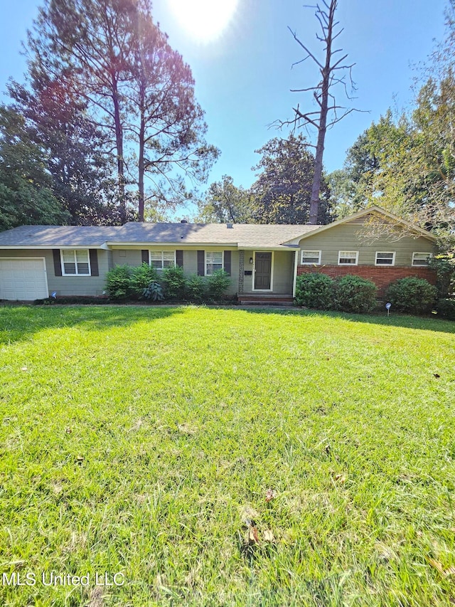 ranch-style house with a garage and a front lawn