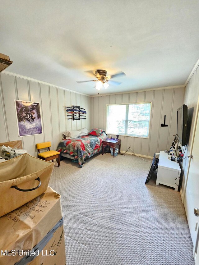 carpeted bedroom with ornamental molding and ceiling fan