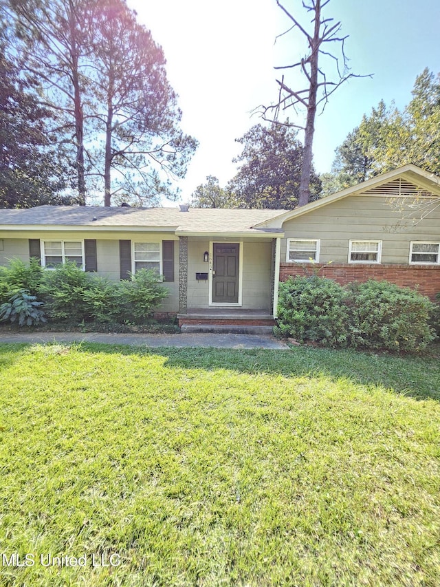 ranch-style house with brick siding and a front lawn