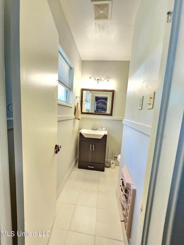 bathroom with vanity, toilet, and tile patterned floors