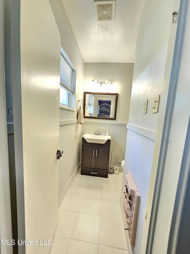 bathroom featuring vanity, tile patterned floors, visible vents, and toilet