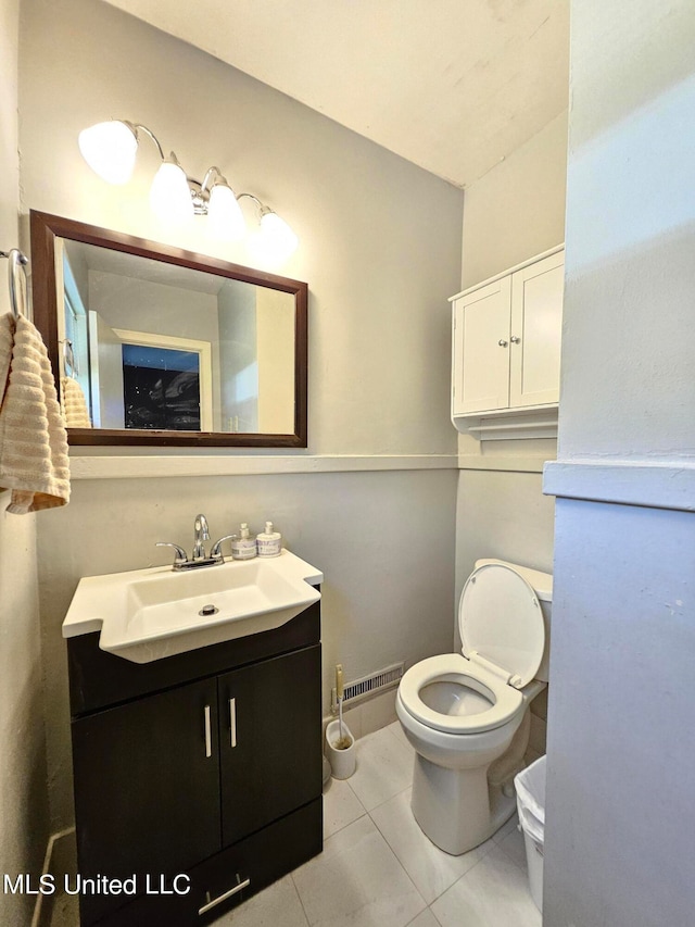 bathroom featuring vanity, toilet, and tile patterned floors