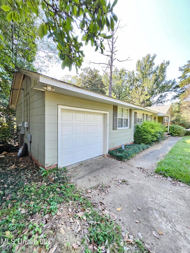 view of side of home featuring a garage