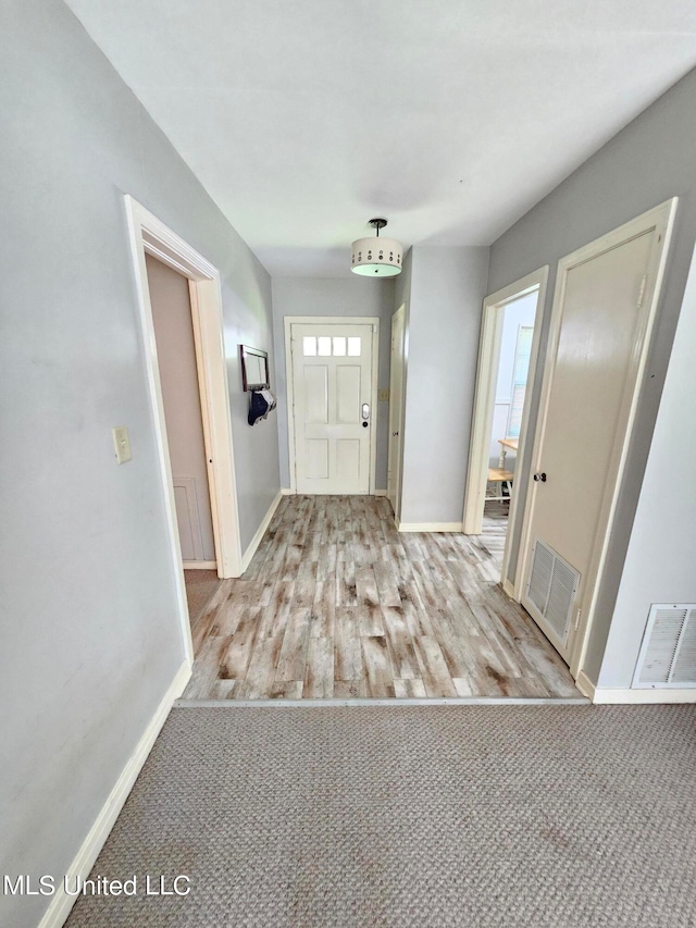 foyer entrance featuring light hardwood / wood-style floors and a wealth of natural light