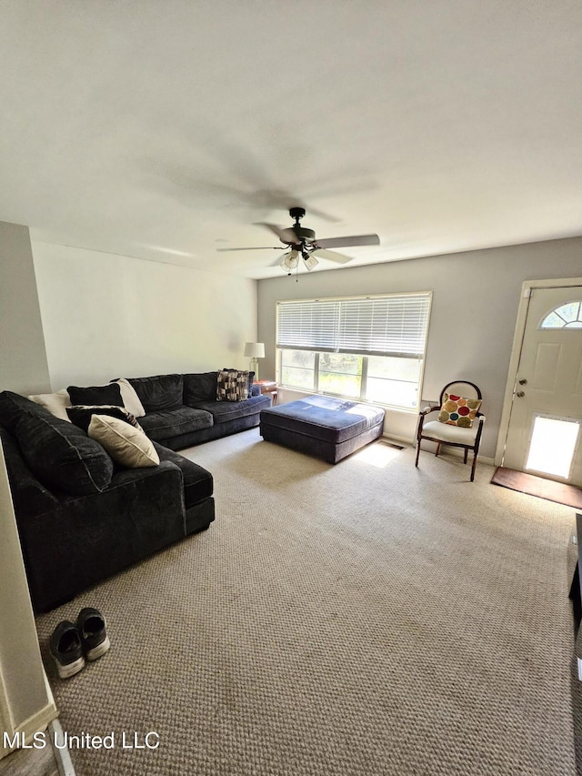 living room featuring plenty of natural light, carpet, and ceiling fan