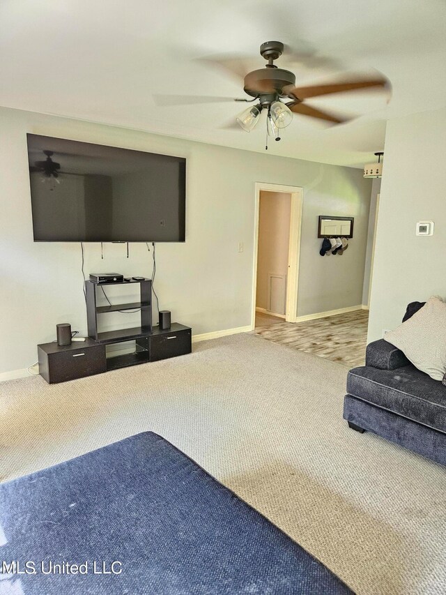 unfurnished living room featuring carpet flooring and ceiling fan