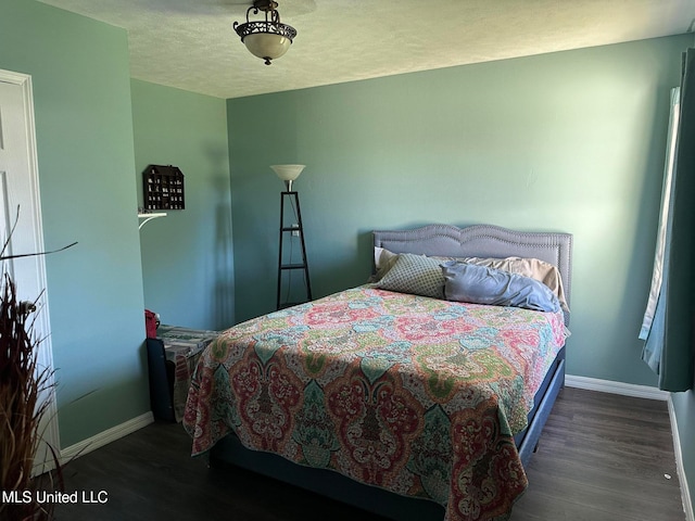 bedroom featuring dark wood-type flooring