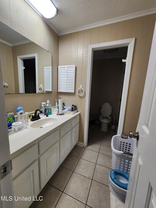 1365 Bruister Rd, Tutwiler, MS 38963 - bathroom featuring ornamental molding, toilet, tile patterned flooring, vanity, and a textured ceiling