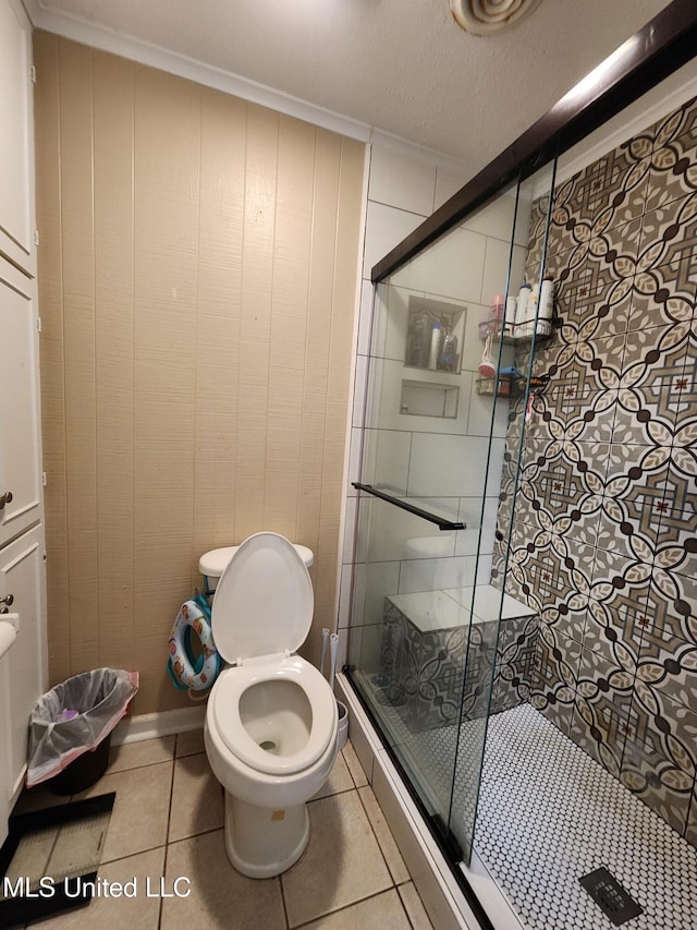 1365 Bruister Rd, Tutwiler, MS 38963 - bathroom featuring a stall shower, toilet, tile patterned flooring, and crown molding