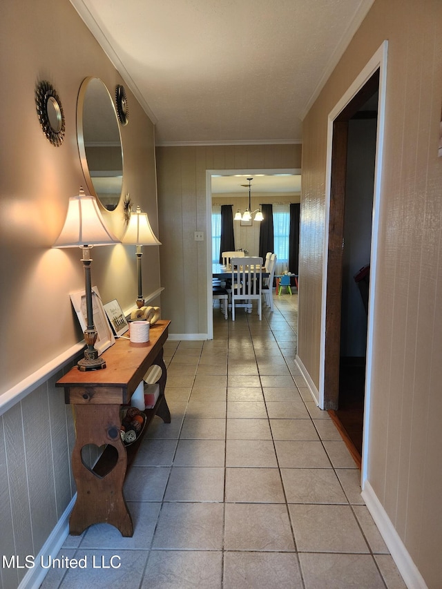 1365 Bruister Rd, Tutwiler, MS 38963 - corridor featuring crown molding, a chandelier, and light tile patterned floors