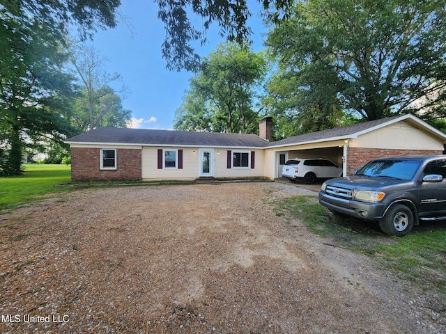 1365 Bruister Rd, Tutwiler, MS 38963 - ranch-style house with driveway, brick siding, a chimney, and a carport