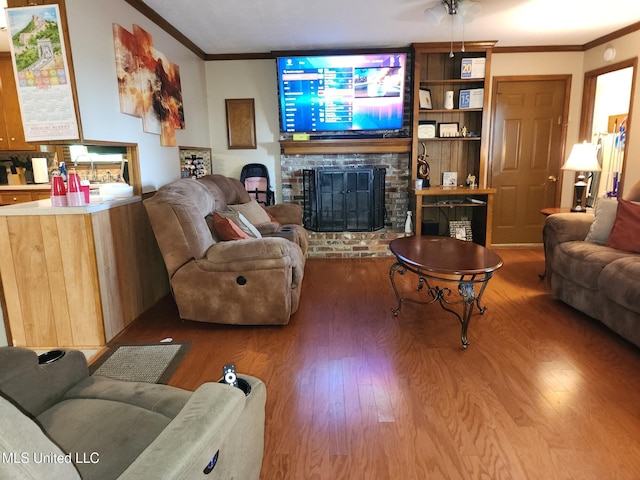 1365 Bruister Rd, Tutwiler, MS 38963 - living room with wood finished floors, crown molding, and a brick fireplace