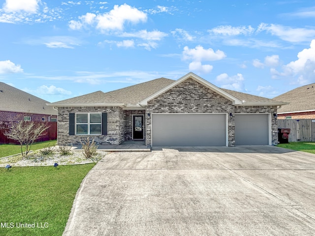 ranch-style home with brick siding, an attached garage, fence, and a shingled roof