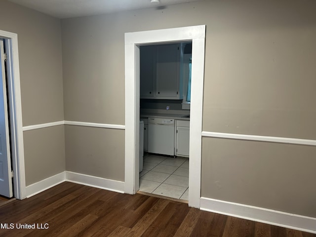 hallway featuring baseboards and dark wood-type flooring