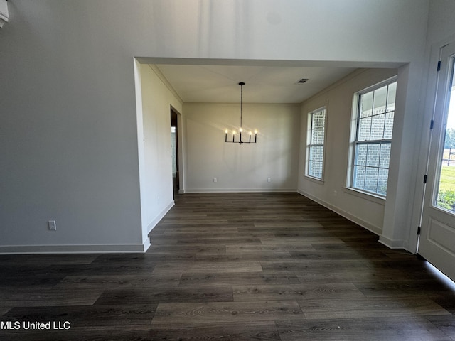 13721 River Grove Ln, Olive Branch, MS 38654 - unfurnished dining area featuring a chandelier, dark wood finished floors, and baseboards