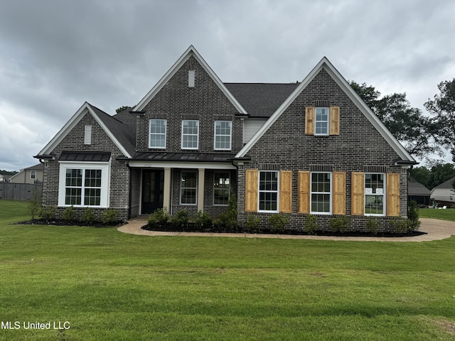13721 River Grove Ln, Olive Branch, MS 38654 - view of front of home with a front lawn, brick siding, and a standing seam roof