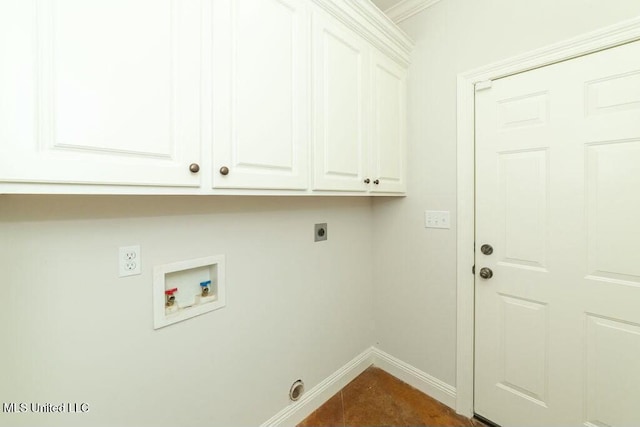 laundry area featuring electric dryer hookup, washer hookup, cabinets, dark tile patterned flooring, and ornamental molding