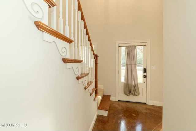 foyer with a towering ceiling