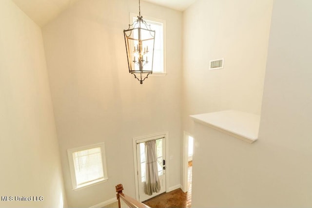 foyer entrance featuring a high ceiling and a chandelier