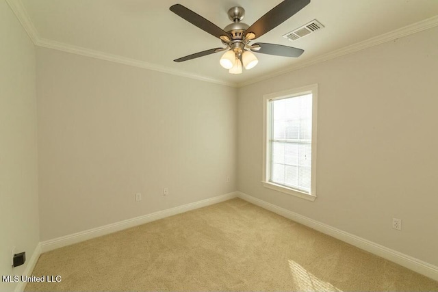 empty room featuring ornamental molding, ceiling fan, and light carpet