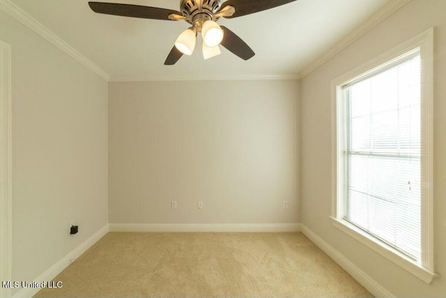 carpeted spare room featuring ceiling fan, crown molding, and plenty of natural light