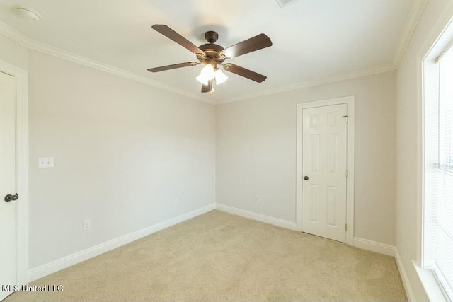 empty room featuring ornamental molding, ceiling fan, and light colored carpet