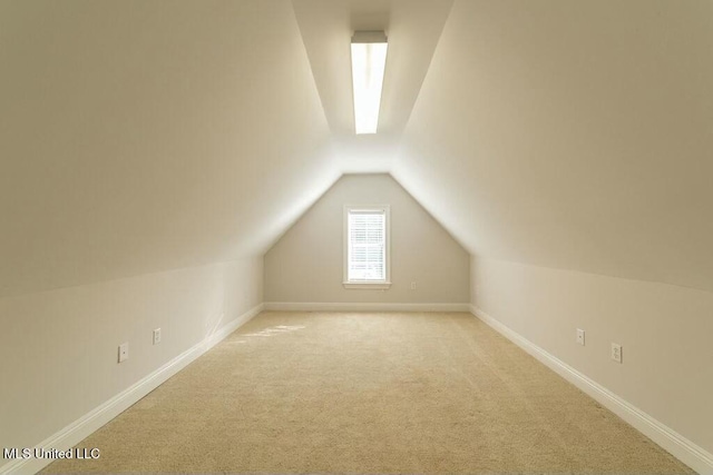 bonus room featuring lofted ceiling and light carpet