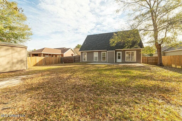 rear view of property featuring a yard and a patio area