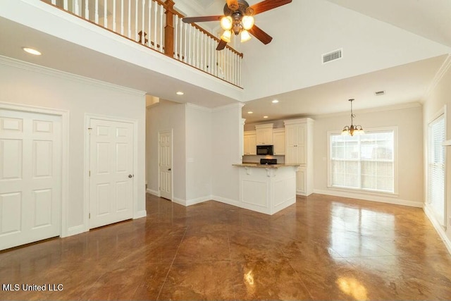 unfurnished living room featuring a high ceiling, crown molding, and ceiling fan with notable chandelier