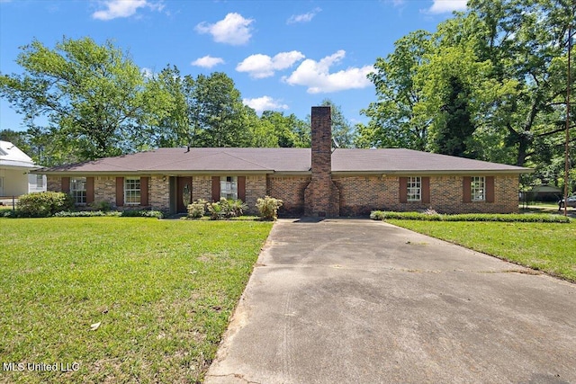 626 N Lexington St, Durant, MS 39063 - ranch-style house with a chimney, a front lawn, driveway, and brick siding