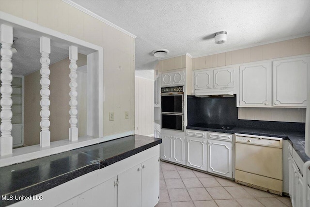 626 N Lexington St, Durant, MS 39063 - kitchen featuring dishwasher, dark countertops, a textured ceiling, white cabinetry, and light tile patterned floors