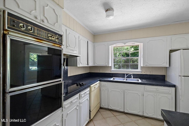 626 N Lexington St, Durant, MS 39063 - kitchen featuring a sink, black appliances, a textured ceiling, dark countertops, and white cabinets