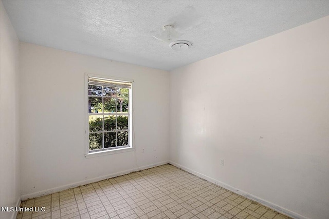 626 N Lexington St, Durant, MS 39063 - empty room featuring baseboards, light flooring, and a textured ceiling