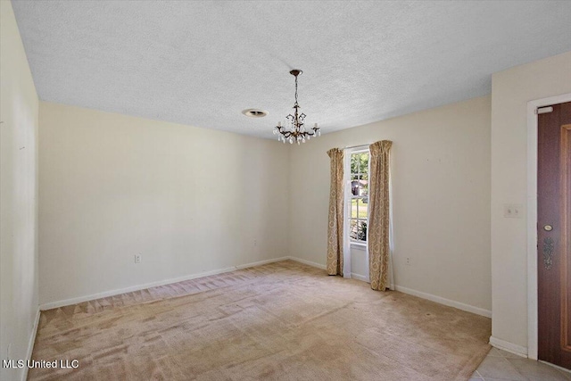 626 N Lexington St, Durant, MS 39063 - empty room featuring a chandelier, carpet, a textured ceiling, and baseboards