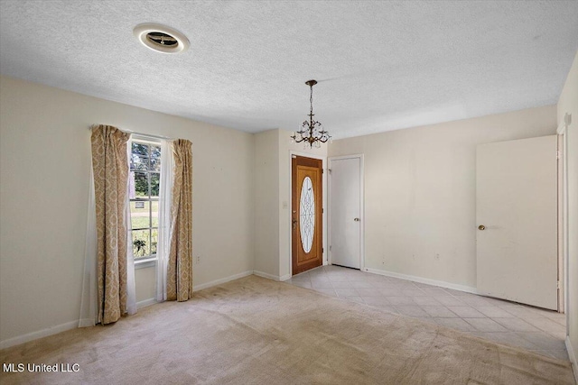 626 N Lexington St, Durant, MS 39063 - unfurnished room featuring a chandelier, carpet, baseboards, tile patterned floors, and a textured ceiling