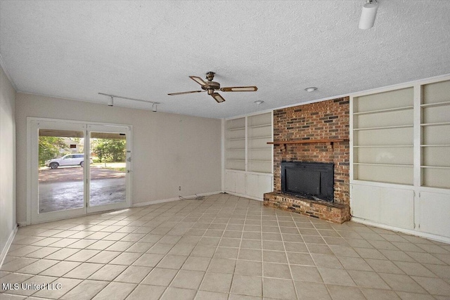 626 N Lexington St, Durant, MS 39063 - unfurnished living room featuring built in shelves, baseboards, ceiling fan, a textured ceiling, and light tile patterned flooring