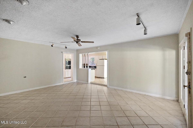 626 N Lexington St, Durant, MS 39063 - unfurnished living room featuring track lighting, a ceiling fan, a textured ceiling, and baseboards