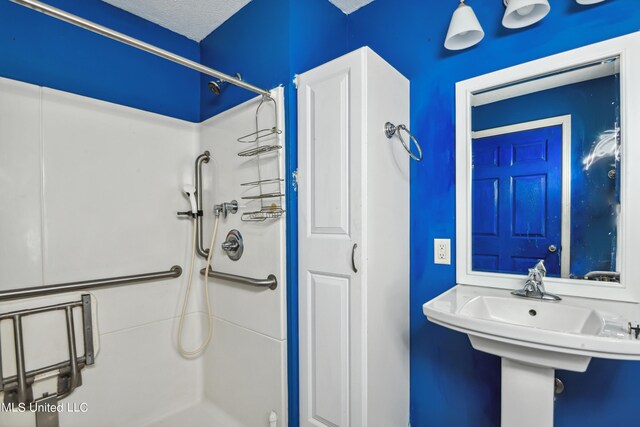 bathroom featuring a textured ceiling and walk in shower