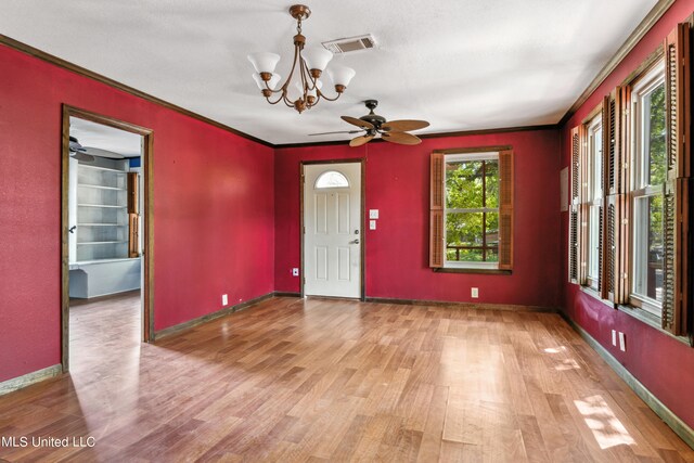 foyer with ornamental molding, light wood-type flooring, and ceiling fan with notable chandelier