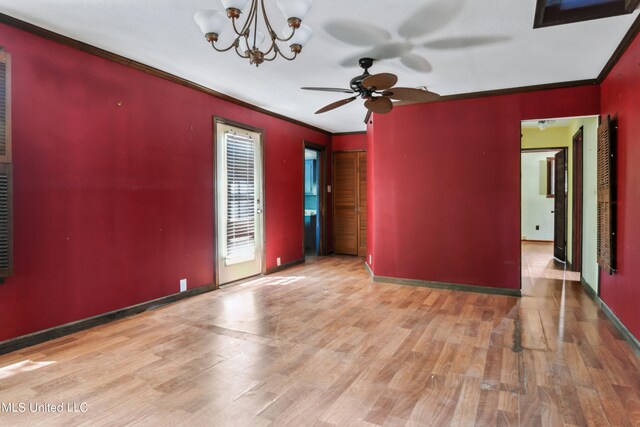 unfurnished room featuring crown molding, light wood-type flooring, and ceiling fan with notable chandelier