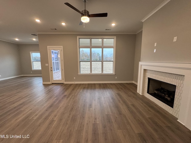 unfurnished living room featuring visible vents, baseboards, dark wood-type flooring, and a brick fireplace