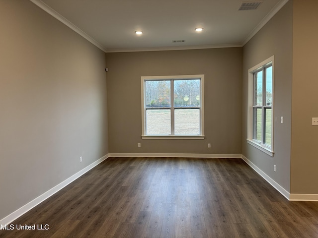 unfurnished room with crown molding, dark wood-style floors, baseboards, and visible vents